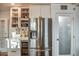 Kitchen with stainless steel refrigerator, wine cooler and glass front upper cabinets at 1402 E Granada Rd, Phoenix, AZ 85006