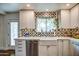 Bright kitchen features a farmhouse sink, stainless steel dishwasher, and ample white cabinetry at 1402 E Granada Rd, Phoenix, AZ 85006