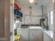 Bright laundry room features washer, dryer, storage shelves, and a water heater at 1402 E Granada Rd, Phoenix, AZ 85006
