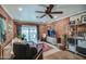 Open living room with brick walls, modern furnishings, and sliding door access to the outdoor patio at 1402 E Granada Rd, Phoenix, AZ 85006