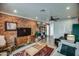 Bright living room with brick walls, modern decor, and a view into other rooms at 1402 E Granada Rd, Phoenix, AZ 85006