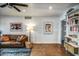 Comfortable living room showcasing a leather sofa, stylish rug, textured walls, and curated bookshelves at 1402 E Granada Rd, Phoenix, AZ 85006