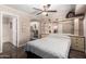Bright bedroom showcasing tile floors, a ceiling fan, and an en-suite bathroom at 1440 N Idaho Rd # 2053, Apache Junction, AZ 85119