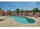 Relax at the community pool featuring blue waters, comfortable seating, and sunny skies at 1440 N Idaho Rd # 2053, Apache Junction, AZ 85119