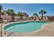 Community pool with clear blue water, surrounded by lounge chairs and palm trees for relaxation at 1440 N Idaho Rd # 2053, Apache Junction, AZ 85119