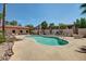 Community pool surrounded by rocks and palm trees perfect for relaxing on a hot day at 1440 N Idaho Rd # 2053, Apache Junction, AZ 85119