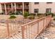 Charming exterior view of a multi-story building with well-maintained landscaping and a cozy bridge at 1440 N Idaho Rd # 2053, Apache Junction, AZ 85119