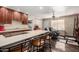Kitchen island with bar seating overlooks a cozy living area with modern fixtures and tile floors at 1440 N Idaho Rd # 2053, Apache Junction, AZ 85119