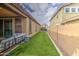 This backyard features a covered patio, artificial turf, and privacy fencing at 14413 W Dahlia Dr, Surprise, AZ 85379