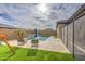This backyard features outdoor furniture, a playset, and a pool at 14413 W Dahlia Dr, Surprise, AZ 85379