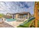 This backyard features a playset and a pool at 14413 W Dahlia Dr, Surprise, AZ 85379