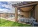 This backyard features a covered patio, artificial turf, and a pool at 14413 W Dahlia Dr, Surprise, AZ 85379