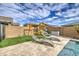This backyard features outdoor furniture, a playset, and a view of the pool at 14413 W Dahlia Dr, Surprise, AZ 85379