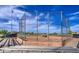 A caged baseball field features bleacher seating with views of the team on the field at 14413 W Dahlia Dr, Surprise, AZ 85379