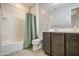 This bathroom features a shower-tub combination, a toilet, and a vanity with modern fixtures at 14413 W Dahlia Dr, Surprise, AZ 85379