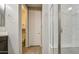 Bright bathroom featuring a glass-enclosed shower and built in storage with dark cabinets at 14413 W Dahlia Dr, Surprise, AZ 85379