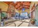 Spacious common area featuring a stone fireplace, vaulted ceilings, ample seating, and large windows for natural light at 14413 W Dahlia Dr, Surprise, AZ 85379