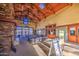 Bright common area with high ceilings, stone fireplace, ample seating, and large windows offering plenty of natural light at 14413 W Dahlia Dr, Surprise, AZ 85379