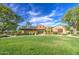 Well-maintained exterior view showcases lush landscaping and inviting entrance to this attractive community building at 14413 W Dahlia Dr, Surprise, AZ 85379