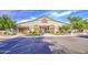 Inviting exterior of building, featuring wood accents, manicured landscaping, and ample parking at 14413 W Dahlia Dr, Surprise, AZ 85379
