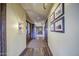 Well-lit hallway featuring elegant decor, decorative wall art and hardwood floors leading to various areas of the building at 14413 W Dahlia Dr, Surprise, AZ 85379