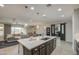 Open concept kitchen with an island, pendant lighting, and views into the dining and living area at 14413 W Dahlia Dr, Surprise, AZ 85379
