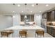 Bright kitchen featuring an island with a white countertop and stylish seating for three at 14413 W Dahlia Dr, Surprise, AZ 85379