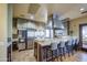 Spacious kitchen with stainless steel appliances, ample counter space, and cozy bar seating for casual dining at 14413 W Dahlia Dr, Surprise, AZ 85379