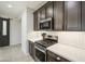 The kitchen offers stainless steel appliances, white backsplash, and wood cabinets at 14413 W Dahlia Dr, Surprise, AZ 85379