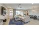 Spacious living room with a sectional sofa, ceiling fan, and dining area at 14413 W Dahlia Dr, Surprise, AZ 85379