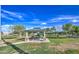 A park gazebo featuring picnic tables surrounded by trees and manicured lawn at 14413 W Dahlia Dr, Surprise, AZ 85379