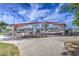A fenced area in a public park with sunshades, picnic tables, and surrounding green space at 14413 W Dahlia Dr, Surprise, AZ 85379