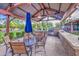 Poolside BBQ area is perfect for outdoor entertaining, complete with seating and grill at 14413 W Dahlia Dr, Surprise, AZ 85379