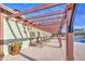 Relaxing poolside with lounge chairs under a pergola, offering shade and comfort at 14413 W Dahlia Dr, Surprise, AZ 85379