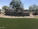 Community entrance with stone monument, Rancho Mercado signage, landscaping, and artificial turf at 14594 W Sand Hills Rd, Surprise, AZ 85387