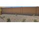 Low-maintenance backyard featuring desert landscaping and a tall privacy wall for a tranquil outdoor space at 15585 W Williams St, Goodyear, AZ 85338