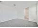 Carpeted bedroom with neutral walls and doorway to bathroom with a shower at 15585 W Williams St, Goodyear, AZ 85338