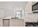 Bright and airy kitchen area featuring stainless steel appliances, white cabinetry, and quartz countertops at 15585 W Williams St, Goodyear, AZ 85338