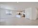 Spacious living room and kitchen area with white walls, recessed lighting, and tiled floor at 15585 W Williams St, Goodyear, AZ 85338