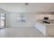 Bright living area with tiled floors, recessed lighting, and views of the kitchen and backyard at 15585 W Williams St, Goodyear, AZ 85338