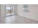 Bright room with sliding glass door, large window, and gray tile flooring at 15585 W Williams St, Goodyear, AZ 85338