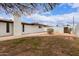 A large backyard with storage shed and a low-maintenance landscape with desert shrubs and trees at 1649 W Carmel Ave, Mesa, AZ 85202