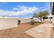 A spacious backyard featuring desert landscaping, a storage shed, and a secure privacy fence at 1649 W Carmel Ave, Mesa, AZ 85202