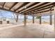 The backyard has a covered patio with large concrete slabs, a built-in BBQ, and a decorative planter at 1649 W Carmel Ave, Mesa, AZ 85202