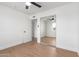 Bedroom featuring neutral paint, laminate flooring, ceiling fan, and mirrored closet at 1649 W Carmel Ave, Mesa, AZ 85202