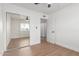 Bedroom with sliding closet door, neutral paint, laminate flooring, and ceiling fan at 1649 W Carmel Ave, Mesa, AZ 85202