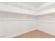 Walk-in closet featuring laminate flooring and bright, white walls at 1649 W Carmel Ave, Mesa, AZ 85202