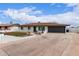Well-maintained single-Gathering home with a two-car garage, landscaped yard, and distinctive white brick accents at 1649 W Carmel Ave, Mesa, AZ 85202