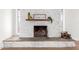 Close-up of a charming white-painted brick fireplace with decorative accents at 1649 W Carmel Ave, Mesa, AZ 85202