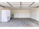 Spacious garage with durable concrete flooring, white walls, and a side-by-side refrigerator at 1649 W Carmel Ave, Mesa, AZ 85202